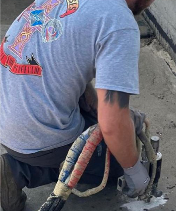 concrete lifting done with a PX-7 pour gun by a technician in a PMC t-shirt